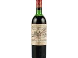 a bottle of wine sitting on top of a white surface