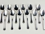 six spoons and six spoons sitting on a table