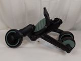 a black and green scooter with wheels on a white surface