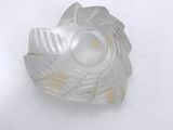 a glass object on a white surface with a white background