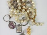 a pile of pearls and other jewelry on a table