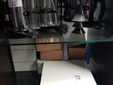 a white box sitting on top of a glass shelf in a cabinet