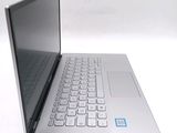 a silver laptop with a keyboard on a white surface