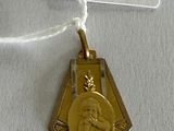 a gold medal with a picture of a woman on it