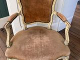an old chair is sitting on a wooden floor next to a door