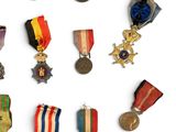 many medals and medals on display on a white surface
