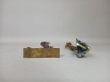 two figurines that are sitting next to each other