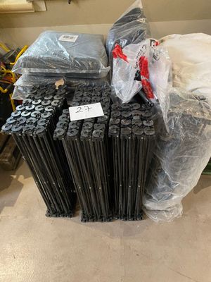 a pile of black rods sitting on the floor