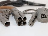 a lot of old guns that are laying on the table