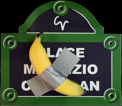 a picture of a banana taped to a sign