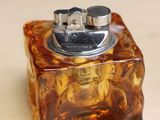a glass box with a lighter in it on a table