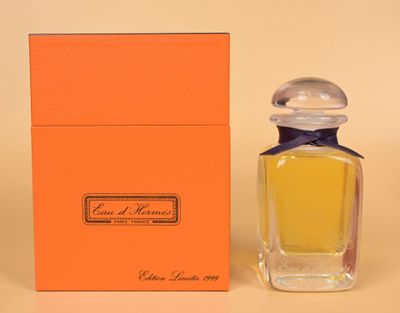 an orange box with a small bottle of perfume next to it