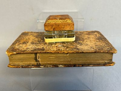 an old book with a piece of bread on top of it