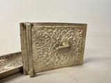 a silver box with a silver handle and a silver box with a silver handle