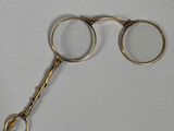 a pair of gold colored scissors on a white surface
