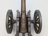 a large antique cannon on display on a white wall