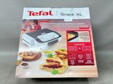 the box of the tefa snack xl is open on the table