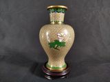 a vase that has a flower on it on a stand
