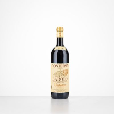 a bottle of wine sitting on top of a white table