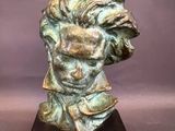 a statue of a man ' s head on a wooden base