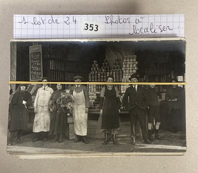 an old photo of a group of people standing in front of a store