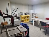 a room with a table, chairs, microwave, and a microwave oven