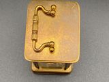 gold plated musical box with a musical instrument in the middle of it