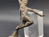 statue of a woman on a skateboard on a clear block
