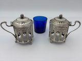 pair of silver plated sugar and pepper shakers with blue glass
