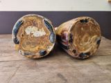 two vases that are sitting on a wooden table