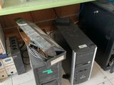 a desk with two computers and a keyboard on it