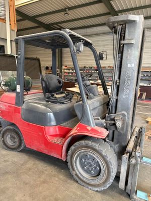 a red forklift truck parked in a warehouse