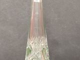 a green glass bottle that is sitting on a table