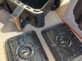 two trays that are sitting on the floor next to a toaster