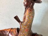 bronze statue of a man riding a horse with a hat on his head