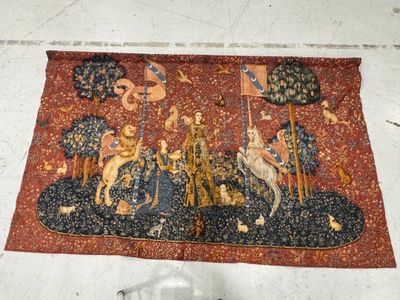 a tapestry with a picture of a man riding a horse