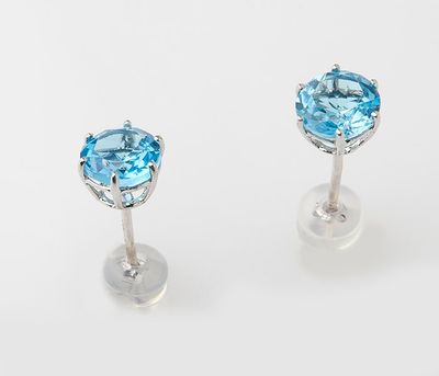 a pair of blue topaze earrings on a white background