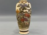 a vase that has flowers on it on a table