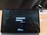 a laptop that is sitting on a table with the samsung logo on it