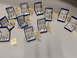 a lot of silver rings in boxes on a table