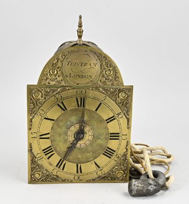 a gold clock with a rope around it