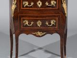 an antique chest of drawers with a marble top on a stand