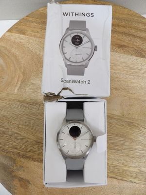 the watch is in the box on the table next to the box
