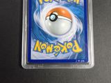 a pokemon card in a plastic case on a table