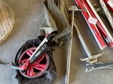 a pile of skis, poles, and a bag on the floor