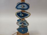 a blue and gold table lamp with a gold base