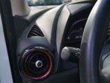 a car dashboard with a steering wheel and a dash button