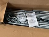a cardboard box with a bunch of metal pipes inside of it