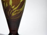 a glass vase with a brown and green design on it