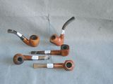 several different types of pipes are lined up on a table
